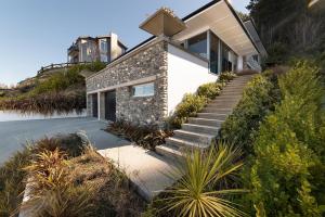 a house on top of a hill with stairs at Luxe Home on the Hill in Queenstown