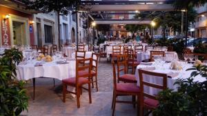 ein Restaurant mit Tischen und Stühlen sowie weißen Tischdecken in der Unterkunft Hotel Rural Ocell Francolí in L’Espluga de Francolí