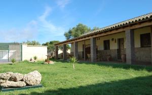 a house with some rocks in the yard at Residencial La Teja in Zahora