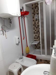 a small bathroom with a sink and a shower at Governor's Inn Apartments in Gibraltar