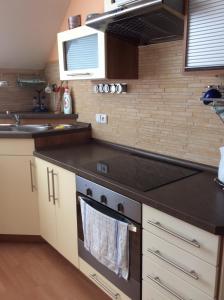 a kitchen with a stove top oven next to a sink at Apartmán Horní Lipová in Lipova Lazne