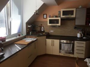 a kitchen with a sink and a stove top oven at Apartmán Horní Lipová in Lipova Lazne