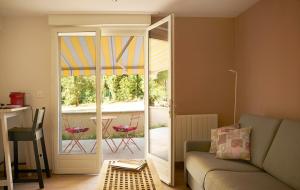 a living room with a couch and a sliding glass door at Revigora in Vienne