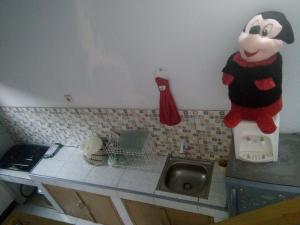 a kitchen counter with a mickey mouse on the wall at Runia Lembang in Bandung