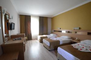 Ένα ή περισσότερα κρεβάτια σε δωμάτιο στο Bulvar Hotel