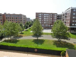 a view of a park with trees and buildings at Loft Gijón in Gijón