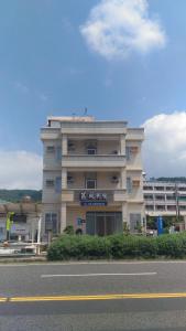 un edificio al lado de una carretera al lado de una calle en Ju Tong Homestay, en Nanwan