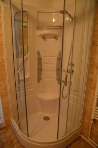 a shower with a glass door in a bathroom at Baza Sportiva Adelina in Cîmpulung