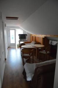 a living room with a table and a piano at Baza Sportiva Adelina in Cîmpulung