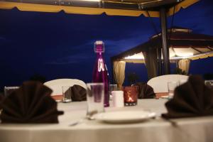 a bottle of wine sitting on top of a table at Brijwasi Lands Inn in Mathura