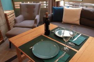 una mesa con una botella de vino y copas. en Piso con piscina y garaje en la Playa de Las Canteras, en Las Palmas de Gran Canaria