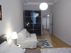 a living room with a white couch and a lamp at Covo Giulia in Genoa