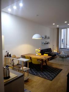 a living room with a table and yellow chairs at Covo Giulia in Genoa