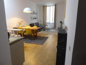 a kitchen and living room with a table and yellow chairs at Covo Giulia in Genoa