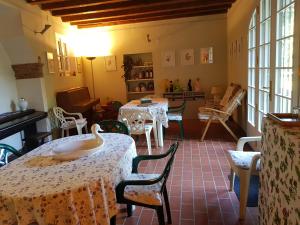 a dining room with two tables and chairs and windows at Casa Antica Mosaici in Trivignano Udinese +28 photos