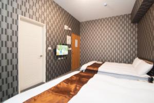Ein Bett oder Betten in einem Zimmer der Unterkunft Yixiang Spring Travel