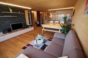 a living room with a couch and a kitchen at Ferienwohnung Feurle´s in Doren