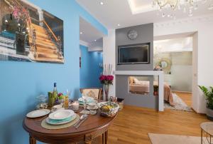 a dining room with a table and a tv at Parliament Sofia - Top Center Luxury Apartment in Sofia