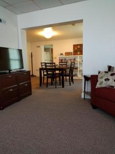 a living room with a table and chairs and a flat screen tv at Pearl's Place in Gettysburg