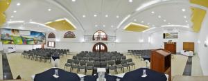 a large room with chairs and a podium in it at Hotel El Lago in Paipa