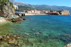 a view of a beach with clear water and buildings at Comfort Inn Old Town in Budva