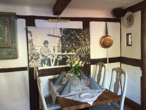 a dining room table with a man sitting at a table at Tunneberga Gästgifvaregård in Jonstorp +14 photos