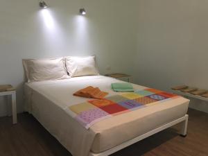 a bedroom with a bed with a quilt on it at La Perlita in Jacó