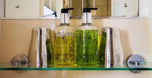 three bottles sitting on a shelf in a bathroom at Rye Hill Farm in Hexham