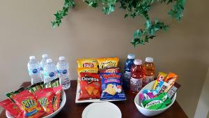 a table with snacks and water and drinks on it at Hotel Le Must in Saint-Marc-des-Carrières