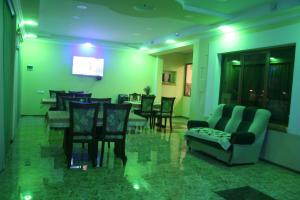 a living room with chairs and a table and a couch at Hotel Noy in Goris
