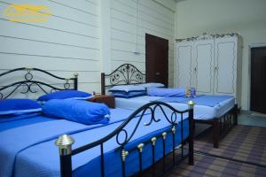 Gulta vai gultas numurā naktsmītnē Teratak Ibunda Guest house