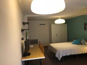 a bedroom with a bed and a television in it at Posada Tintes in Cuenca