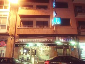 a store on the corner of a street at night at Hotel orly in Xinzo de Limia