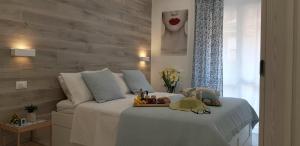 a bedroom with a bed with a tray on it at Martin Holiday Apartments in Giardini Naxos