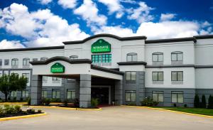 a white building with a market hotel at Wingate by Wyndham Columbia in Columbia