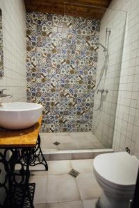 a bathroom with a toilet and a sink and a shower at Green Sheep Boutique Hotel in Stepantsminda