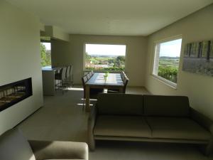 a living room with a couch and a table at Fleur d’ Amour in Heuvelland