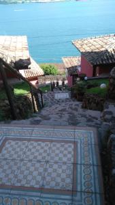 einen Blick auf ein Haus mit dem Meer im Hintergrund in der Unterkunft Chalés Bocaina in Ilhabela