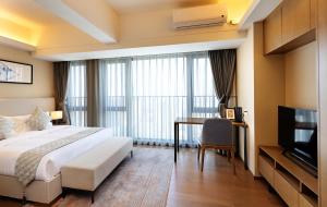 Postel nebo postele na pokoji v ubytování Yuwa Serviced Residence