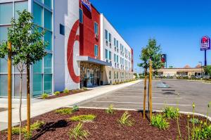 a building with a large red sign on the side of it at Motel 6-Livingston, CA - Merced County in Livingston