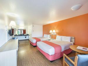a hotel room with two beds and a table at Motel 6 Gold Beach in Gold Beach