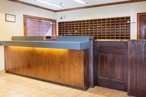 a bar in a room with a wall of wine bottles at Motel 6-Fayetteville, NC - Fort Liberty Area in Fayetteville
