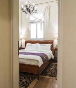 um quarto com uma cama e um lustre em Boutique Hotel 1905 em Xanthi