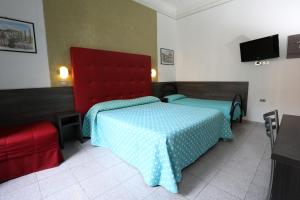 a bedroom with a bed and a red head board at Hotel Piola in Milan