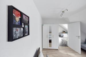 a living room with several pictures on the wall at Wohnung 1- nur 5 min. zum Europapark in Ettenheim