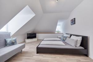 a living room with two beds and a couch at Wohnung 1- nur 5 min. zum Europapark in Ettenheim