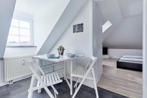 a dining room with a table and two chairs at Wohnung 1- nur 5 min. zum Europapark in Ettenheim +8 photos