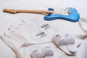 a guitar and a pair of white socks and a pair of shoes at Hard Rock Hotel Desaru Coast in Desaru