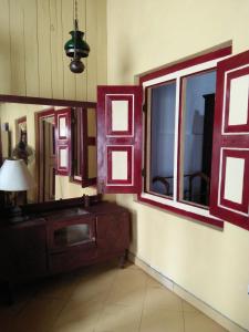 a room with two mirrors and a dresser and a lamp at Beatrice House Galle Fort in Galle
