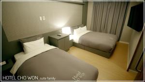 Postel nebo postele na pokoji v ubytování Hotel Chowon